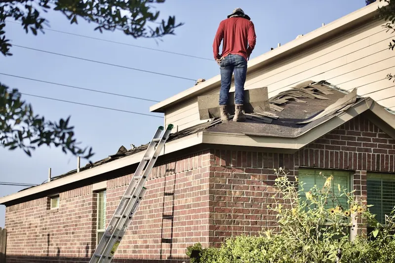 Professional roofer working on a residential roof in Arlington Forest